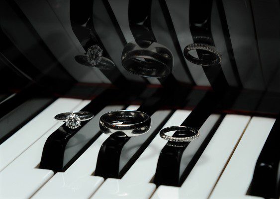 A piano keyboard with several different rings on it.